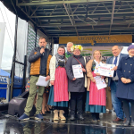 Koło Gospodyń Wiejskich Stary Ujazd i członkowie komisji konkursowej pozujący do wspólnego zdjęcia na scenie w Niezdrowicach.